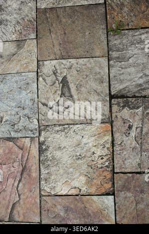 High-resolution abstract background featuring the rough and porous texture of natural stone tiles. The composition highlights the organic patterns, cr Stock Photo
