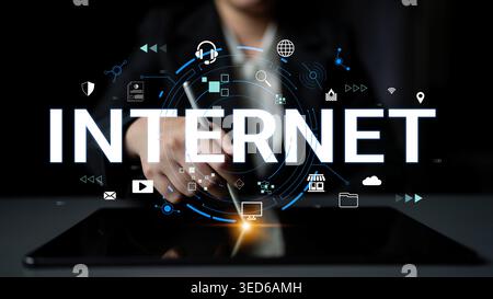 Modern Business Professional Engaging with Digital Technology and Internet Connectivity on Tablet Device in Dark Office Setting Haptic. Stock Photo