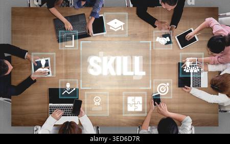 Top View of Diverse Professionals Collaborating on Skill Development with Digital Devices and Icons on a Table in a Modern Workspace Fluxor. Stock Photo