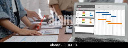 Project planning software for brisk business project management on the computer screen showing timeline chart of the team project Stock Photo
