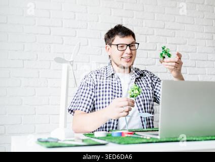 Renewable energy. Distance learning. Young man making renewable energy project dummy teaching online Stock Photo