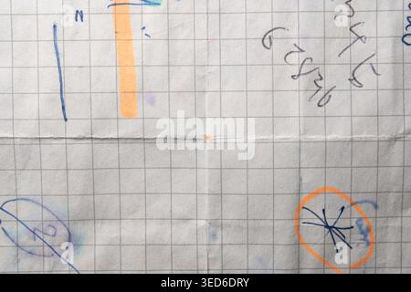 Folded Graph Paper Background with Handwritten Math Scribbles and Blue Ink Doodles Stock Photo