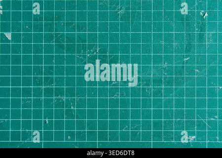 Worn Green Self Healing Cutting Mat Background with Grid Lines and Scratches Stock Photo