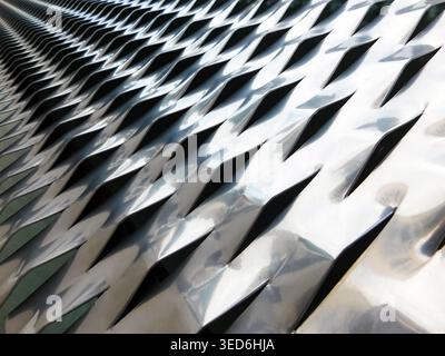Shiny expanded metal mesh texture close-up with diamond pattern, industrial steel background for design Stock Photo