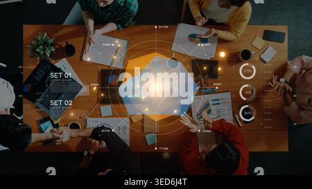 A diverse team collaborates in a business meeting, analyzing data and financial reports to develop effective strategies and make informed decisions Stock Photo