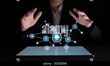 A business professional hands interact with floating cloud technology icons, representing connectivity and innovation in a digital workspace on a dark Stock Photo