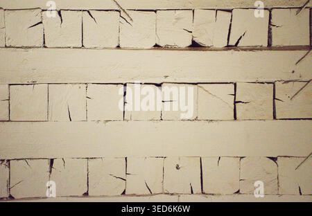 White painted wooden planks with cracked rustic texture background and copy space. Weathered wood surface wallpaper with vintage painted boards. Stock Photo