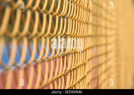 close up of yellow iron door wire net background and texture Stock Photo