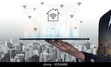 This image showcases smart home technology represented on a digital tablet, highlighting the integration of wireless signals and urban elements in a Stock Photo