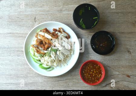 steamed rice topping chop crispy fried and boiled chicken on plate with chili sauce couple soup Stock Photo