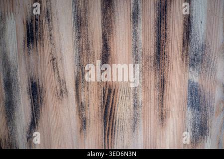 Vertical brush marks on plaster surface, earthy beige and charcoal streaks, coarse grain and distressed Stock Photo