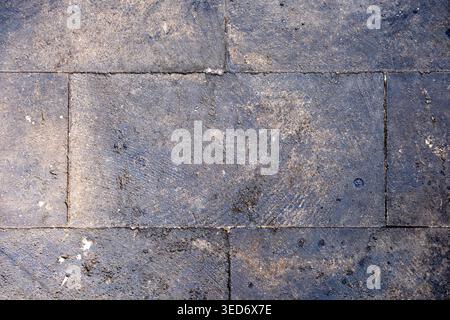 Top view of stone pavement floor with natural dirt and worn texture. Suitable for urban backgrounds, outdoor flooring references, architecture. Stock Photo