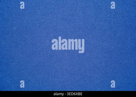 Close-up of blue fabric texture with detailed woven textile pattern. Suitable for fashion backgrounds, textile industry concepts, clothing design. Stock Photo