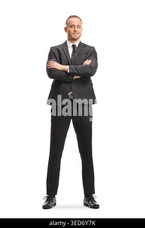 Young man in a black suit with crossed arms isolated on white background Stock Photo