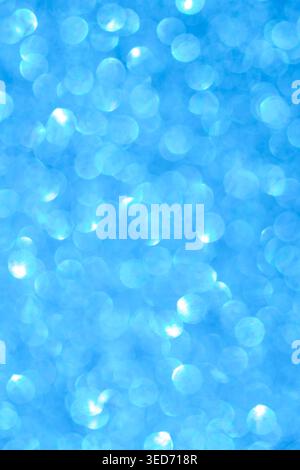 Vertical blue abstract bokeh background with many glowing light circles, soft blur, front view, decorative digital background Stock Photo