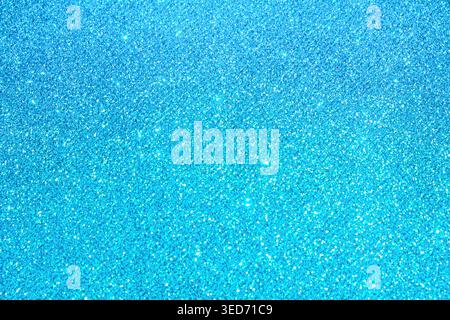 Blue abstract glitter texture background with shimmering bokeh-like particles, front view, luminous decorative surface Stock Photo