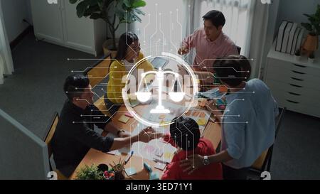 A group of diverse professionals engages in collaborative brainstorming, highlighted by a digital scale symbol, emphasizing balance and innovative Stock Photo