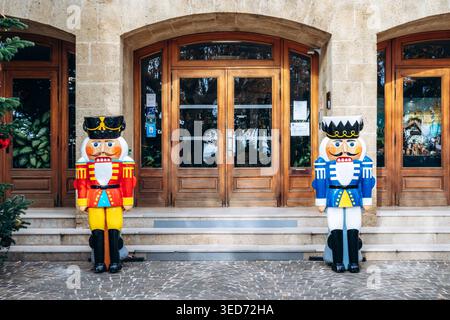 Le Lavandou, France - December 8, 2025: Town hall decorated for Christmas with festive tree, nutcracker figures and Santa Claus sculpture in front of Stock Photo