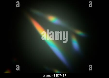 Abstract light refractions forming colorful streaks and glows on dark background Stock Photo
