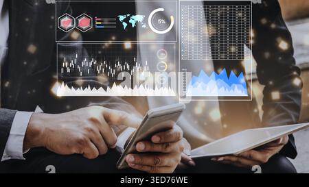 Business professionals analyzing data and charts on smartphone and tablet with digital graphs and statistics in a modern business environment Gluon. Stock Photo
