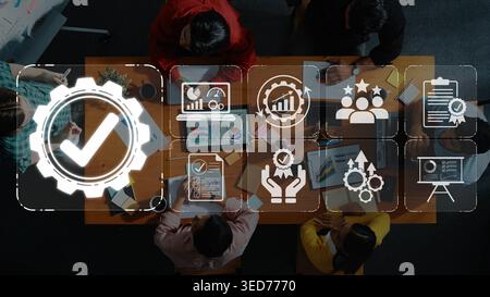 Top-Down View of Team Collaboration with Business Icons Representing Success, Growth, and Strategy on Office Table with Laptops and Notebooks Sigmoid Stock Photo