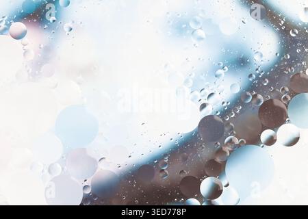 Oil with water round different sizes bubbles in blue and pink tones blur effect macro Stock Photo