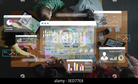 Teams Collaborating on Key Performance Indicators with Graphs and Charts on a Table, Analyzing Data with Laptops and Tablets for Business Growth Gluon Stock Photo