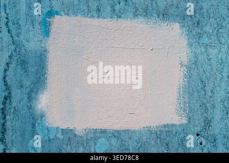 Faded turquoise plaster panel, pale center, uneven paint layers, subtle flaking and weathered edges, ideal for retro poster mockups and urban art comp Stock Photo