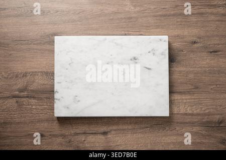 Marble board on wooden table with large copy space top view minimal kitchen background for food presentation branding mock up and design Stock Photo