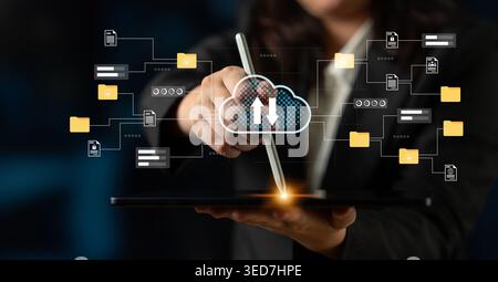 Professional individual uses a tablet for uploading data to the cloud, showcasing modern technology and digital connection in a dynamic office Stock Photo