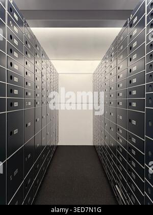 Two rows of partly decommissioned safe deposit boxes in a room Stock Photo