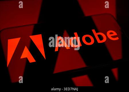 Paris, France - May 4, 2026: The Adobe logo on a dark red background, showcasing the leading creative software and digital media company. Stock Photo