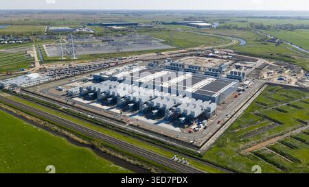 Aerial view of Datacenter Westpoort featuring cooling units and solar panels on the roof surrounded by green fields in Groningen, Groningen, Netherlan Stock Photo