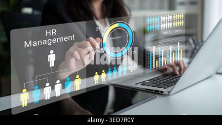 A professional interacts with advanced digital tools for HR management, displaying analytics and performance metrics through visual data in a modern Stock Photo