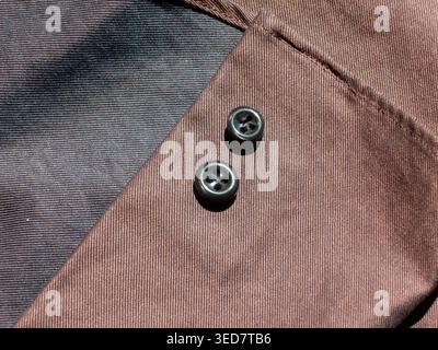 Black buttons on brown fabric macro bacground Stock Photo
