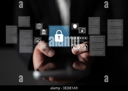 A hand holding a smartphone displays digital security icons, locks, and privacy symbols, emphasizing online safety and data protection in a modern Stock Photo