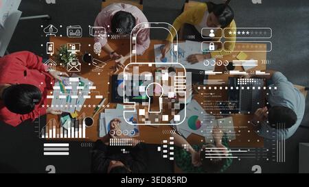 A diverse team collaborates on data analysis in a contemporary office, integrating digital security concepts with visuals, emphasizing teamwork and Stock Photo