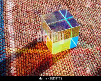 Colored glass cube prism on a blanket object Stock Photo