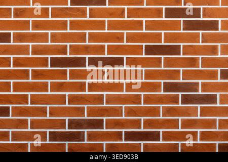 Red Brick Wall Texture Background. Clean red brick wall with white mortar lines, ideal as a construction, architecture, or textured background. Stock Photo