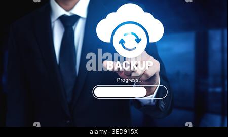 Businessman engaged with cloud backup technology on a digital screen, illustrating data storage and security processes in a modern office setting Stock Photo