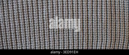 Gray knitted textile showing a textured waffle weave. Pattern and background Stock Photo