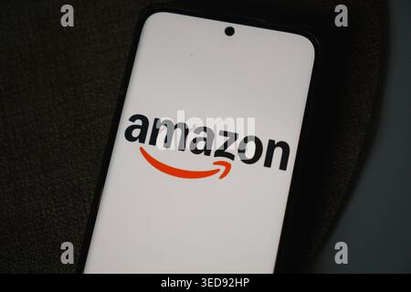 The Amazon logo displayed on a smartphone screen Stock Photo