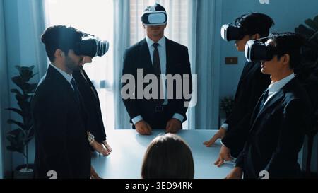 Professional project manager working on laptop and sending data analysis to business people by using VR glass with hologram of financial data analysis Stock Photo