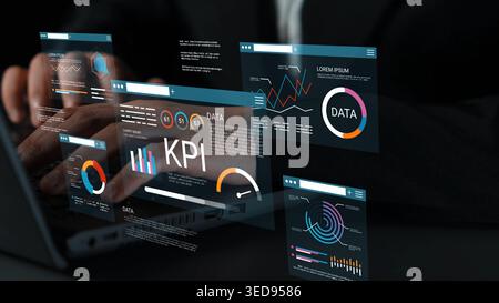 Hands typing on a laptop while interacting with digital data visualizations and KPI graphics, showcasing modern business analytics concepts and Stock Photo