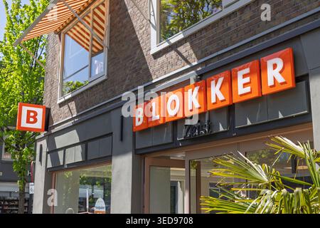 Zeist, Netherlands, April 28, 2026. The bright orange signage of a Blokker household goods store located in a busy Dutch shopping street on a clear da Stock Photo