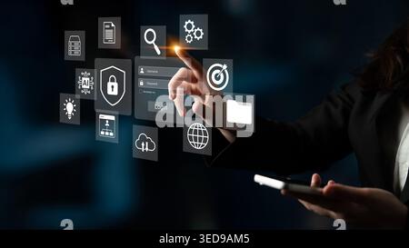 A professional woman engages with a sleek digital interface, highlighting modern technology concepts such as data management, security, and Stock Photo
