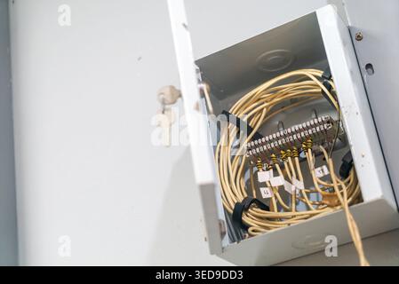 An open electrical box showing organized wiring connections and cables, highlighting safety and installation aspects for electrical systems in a comme Stock Photo