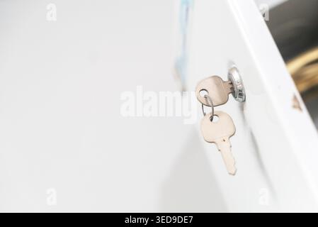 Close-up image of a key inserted in a lock, symbolizing security and access control in various environments like homes and offices. Stock Photo