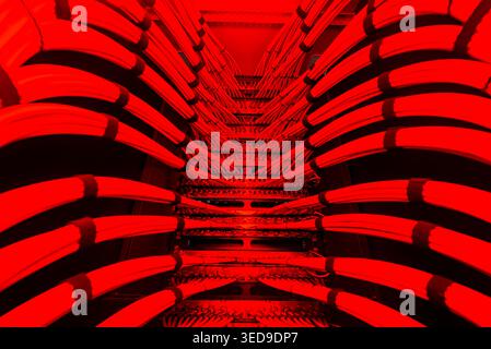 Explore a striking abstract art piece dominated by bold red tones, featuring lines and patterns that create a dynamic visual experience and intrigue. Stock Photo