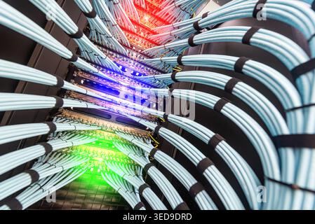 Vibrant fiber optic cables are elegantly arranged in a server rack, showcasing the intricate design and advanced technology vital for data transmissio Stock Photo
